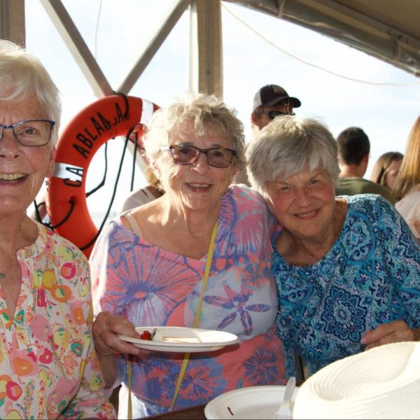 Several women smiling on board a cruise ship
