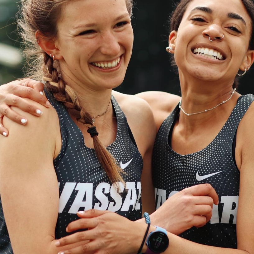 Two young women embracing at a race